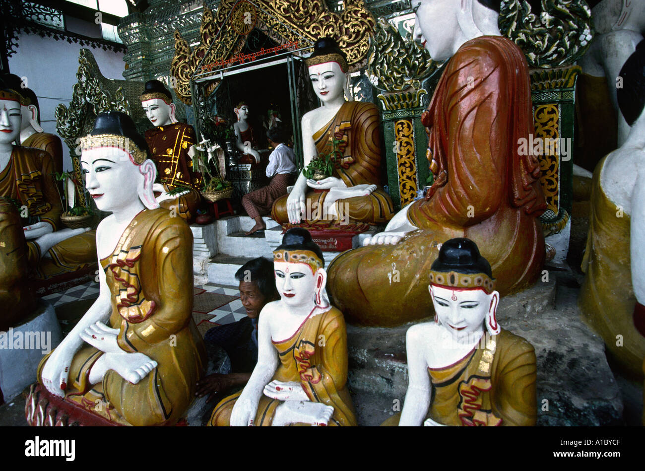 Myanmar Burma Yangon Rangoon Shwedagon Pagoda Men with Buddha figures Stock Photo