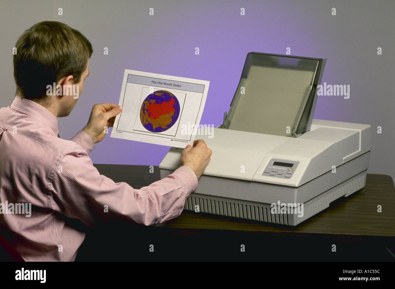 Mark Judge holds up a sample produced by the Calcomp color printer model released Stock Photo