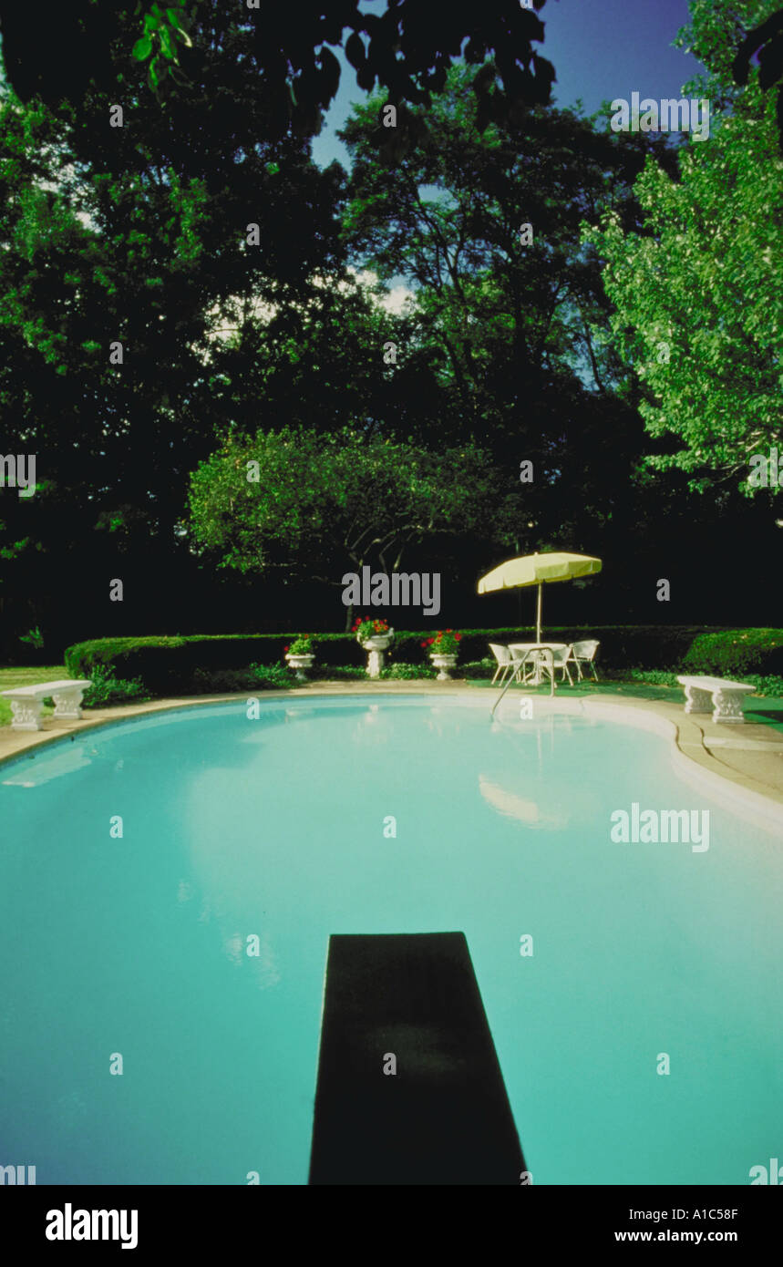 Swimming pool with diving board at private residence Stock Photo Alamy
