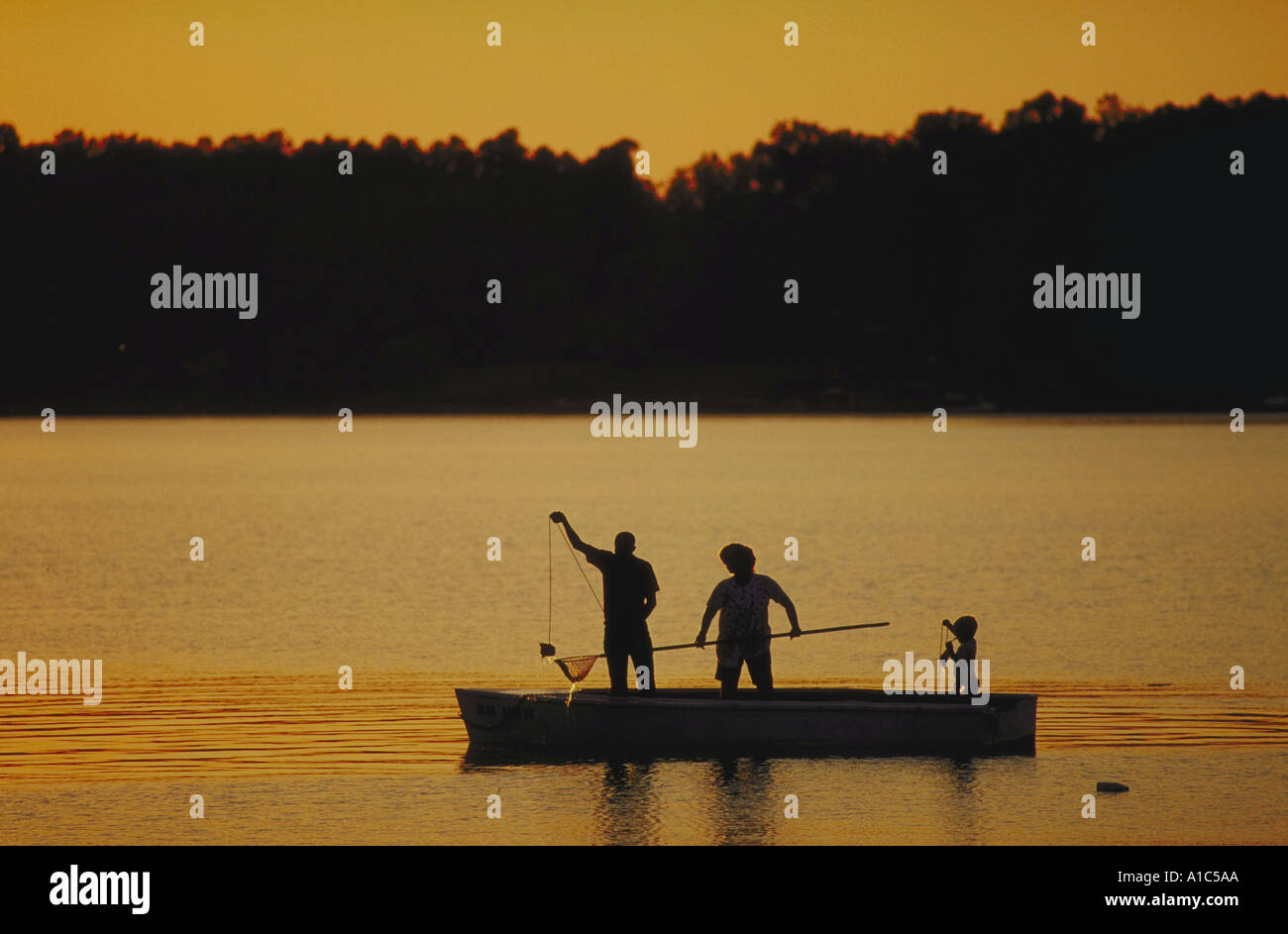 Silhouette of family fishing at sunset Stock Photo - Alamy