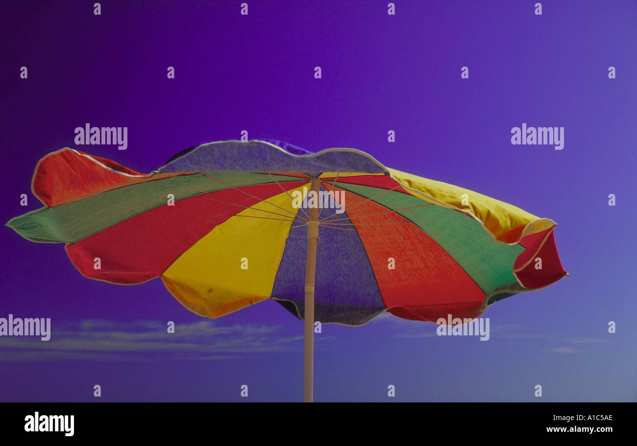 Beach umbrella blowing in the wind Stock Photo Alamy
