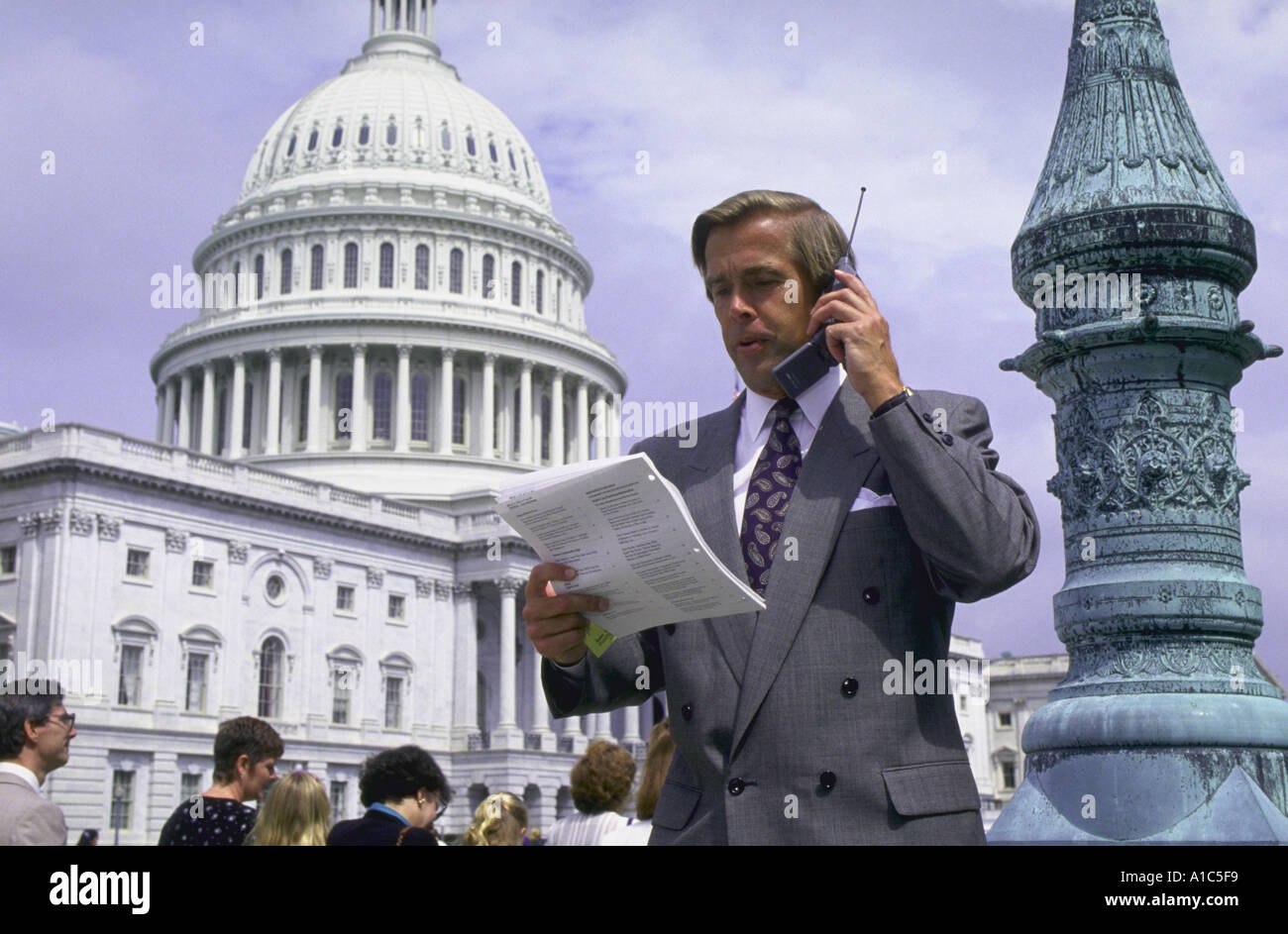 Healthcare industry lobbyist on cellular telephone in front of United States Capitol dome Washington DC Stock Photo