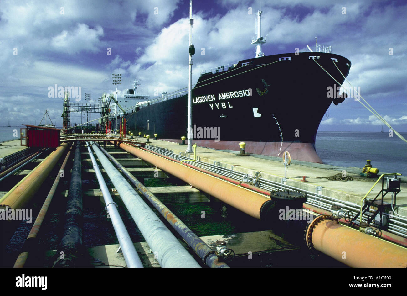 Pipeline and an Lagoven Oil Company oil tanker docked on the shore of Lake Maracaibo Zulia State Venezuela Stock Photo