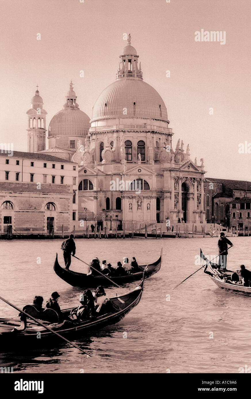 Gondolas on the Grand Canal Venice with the Church of the Salute in the background toned black white Stock Photo
