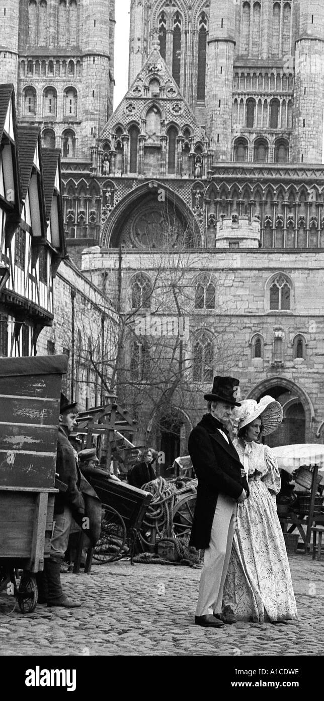 Couple in period costume with Lincoln Cathedral in the background to appear in TV production of Oliver Twist. Stock Photo