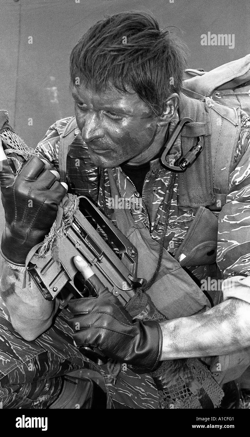 Close shot of military society member dressed in Vietnam period special forces combat equipment with M16 rifle Stock Photo