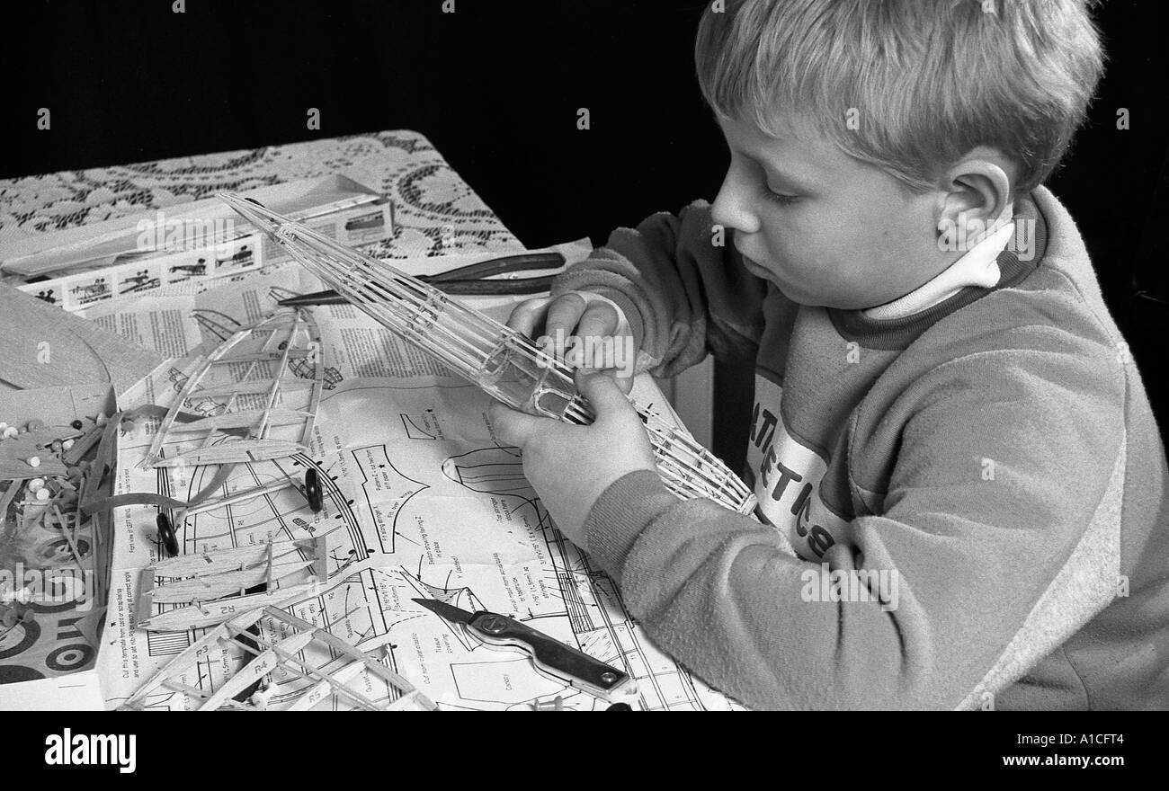 Young boy building balsa wood flying scale model aeroplane. Stock Photo