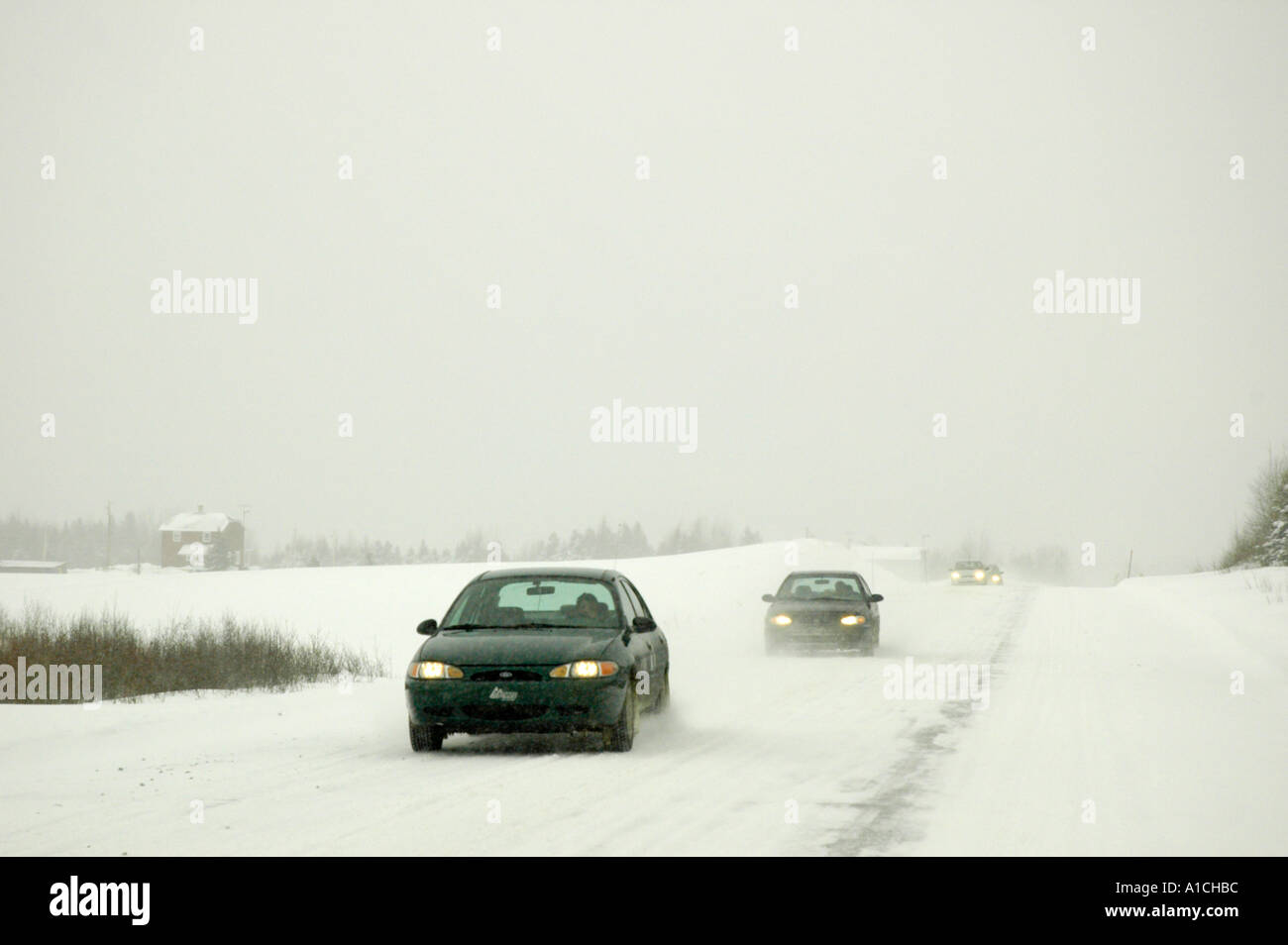 Driving on a rural road secondary road in Quebec Canada during a snow storm The road is snow packed and slippery Stock Photo