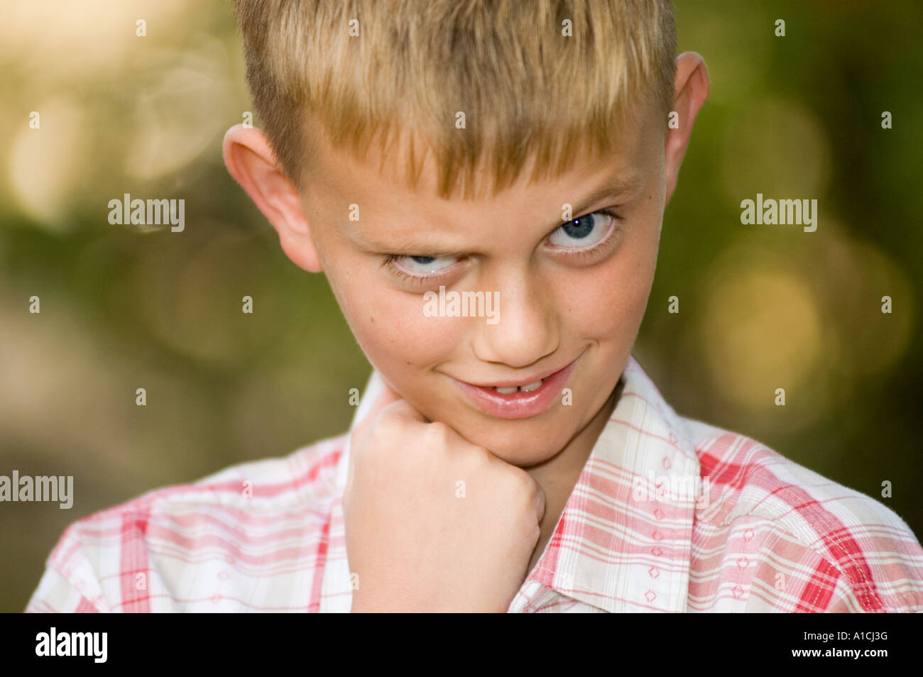 Nine year old boy with a mischievous look on his face Stock Photo - Alamy