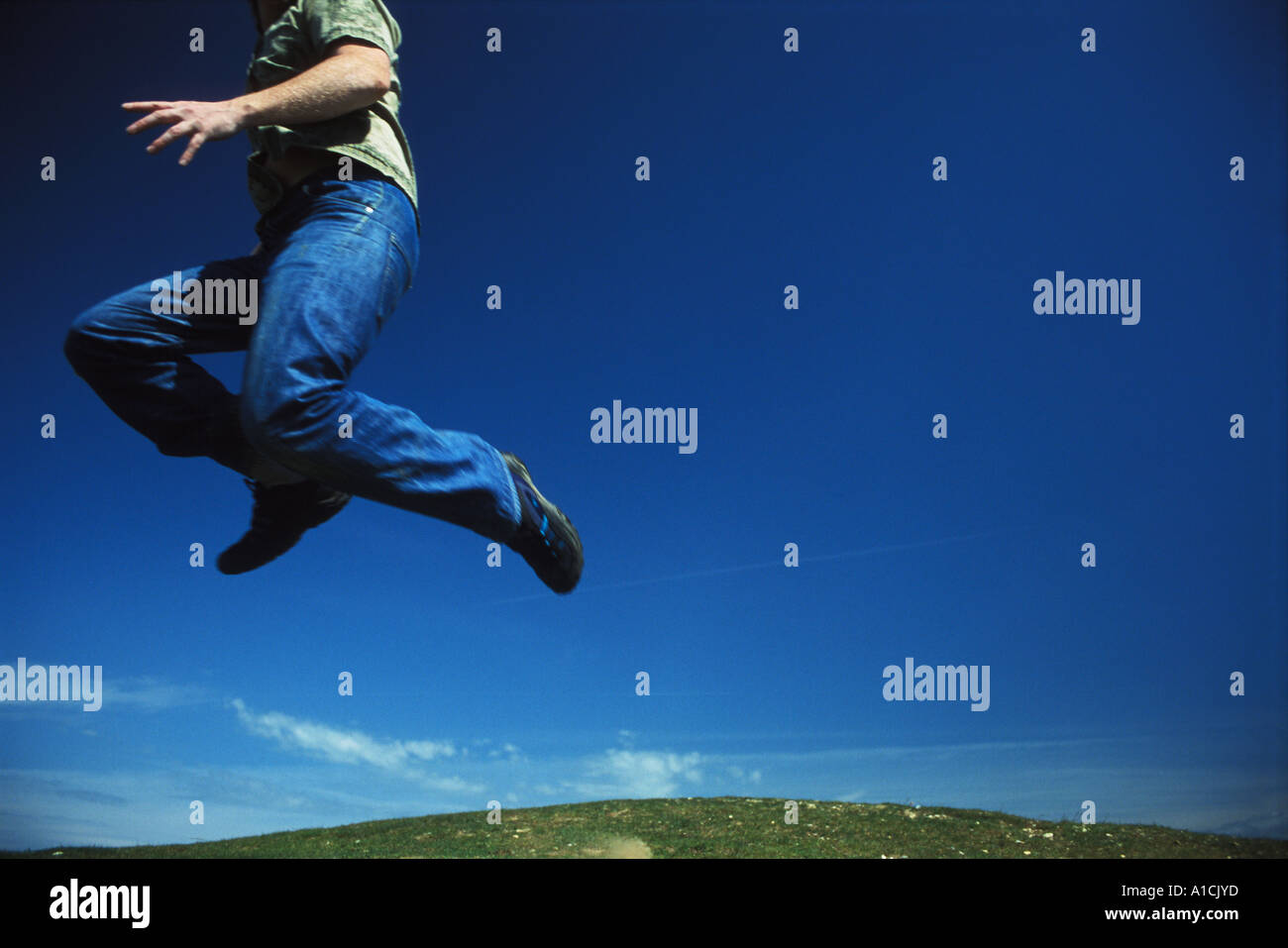 Young man jumping against blue sky hi-res stock photography and images ...