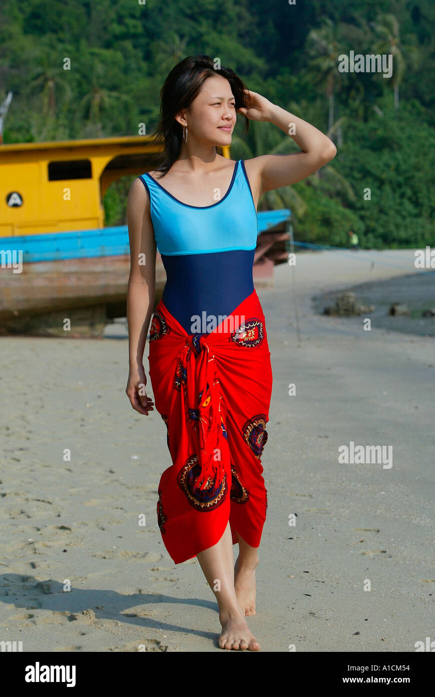Young woman in bathing suit and sarong walks on beach Pulau Pangkor island  Malaysia Stock Photo - Alamy