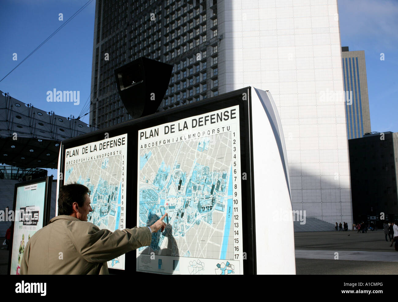 Man looks at map in La Defense, Paris Stock Photo