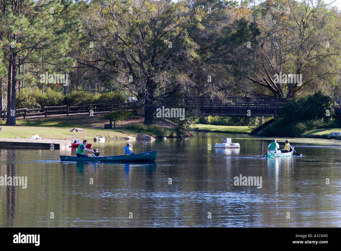 Visitors canoe and kayak on lake in Disney World Fort Wilderness