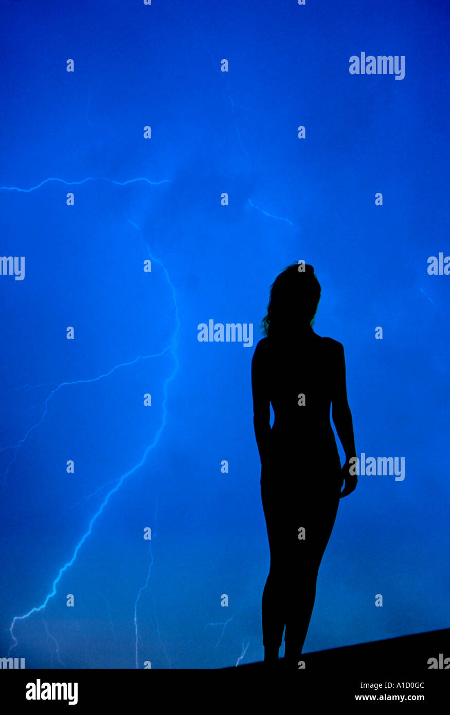 Silhouette woman lightning storm clouds hires stock photography and