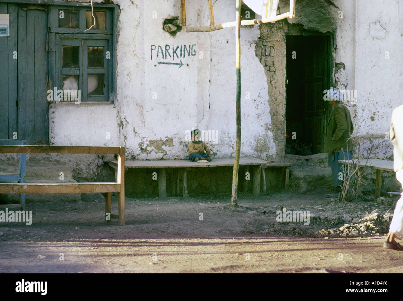 child sittingoutside hotel bamian street scene Stock Photo