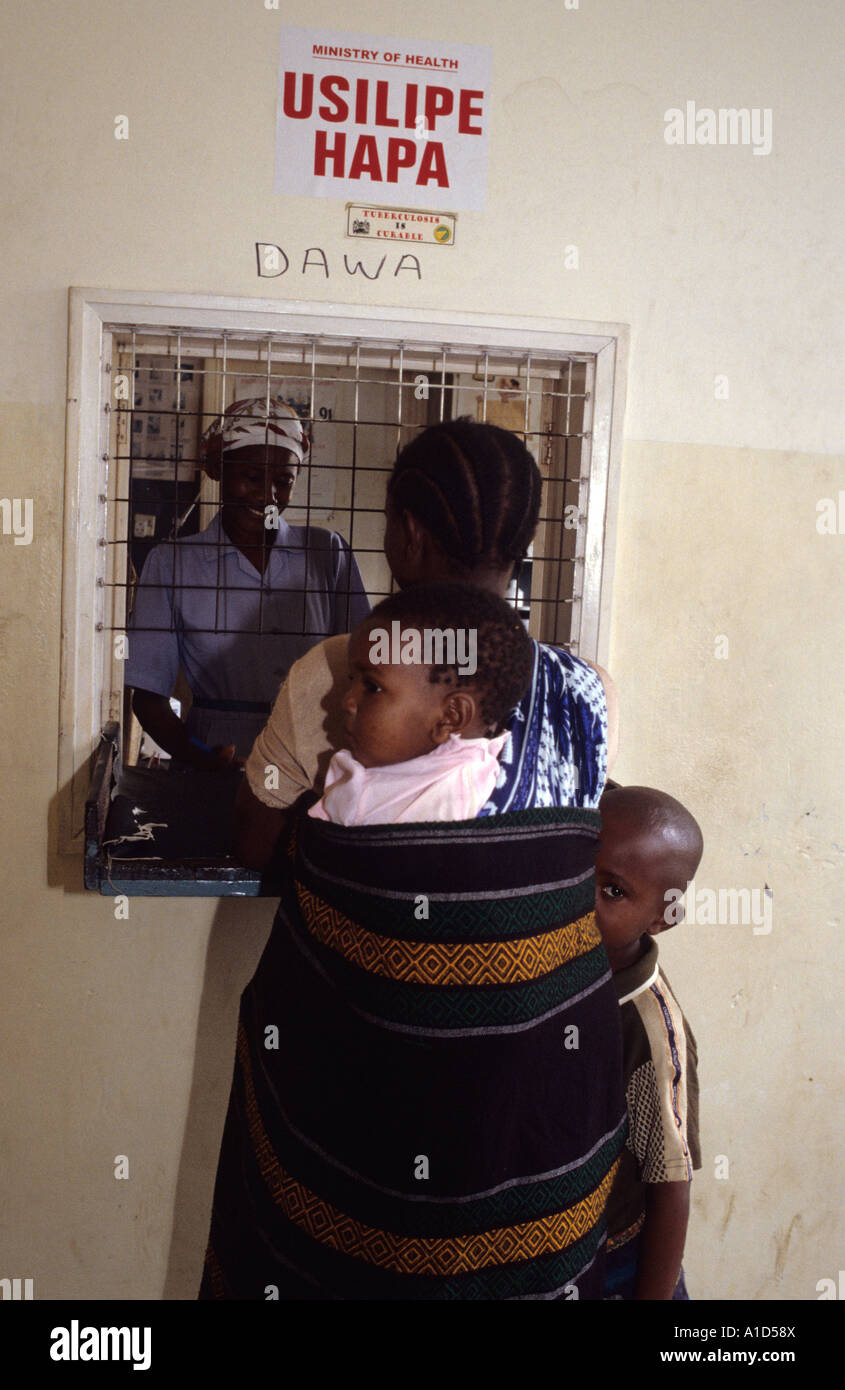 Mombassa,Kenya. Mother collecting medecines at pharmacy counter Stock Photo