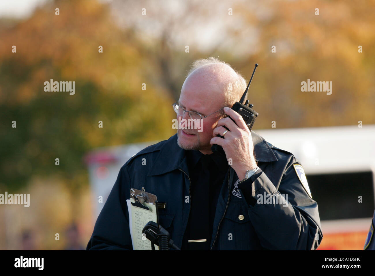 A police detective listening to the radio at his ear Stock Photo