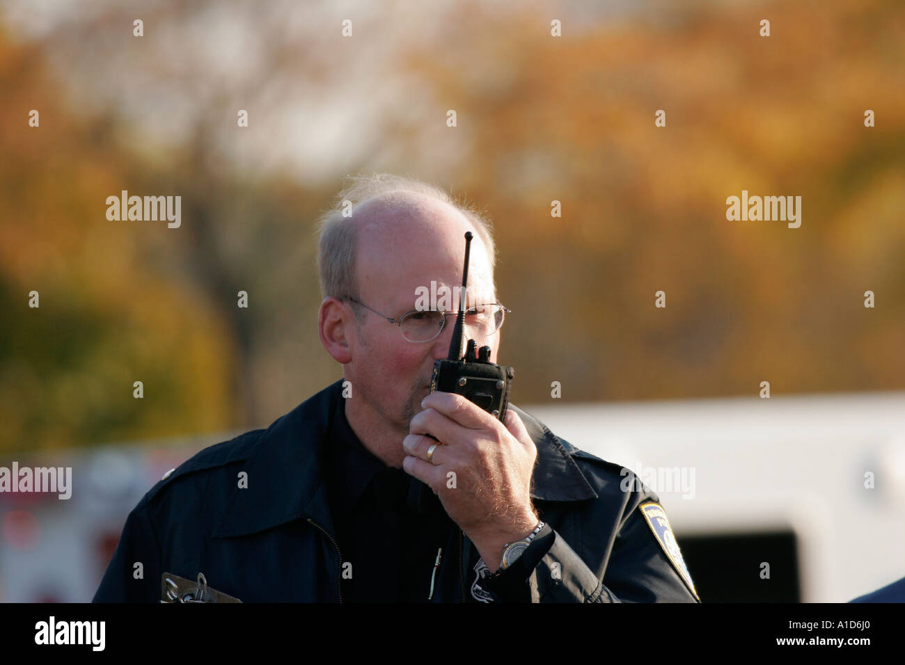 A police detective talking on a radio Stock Photo