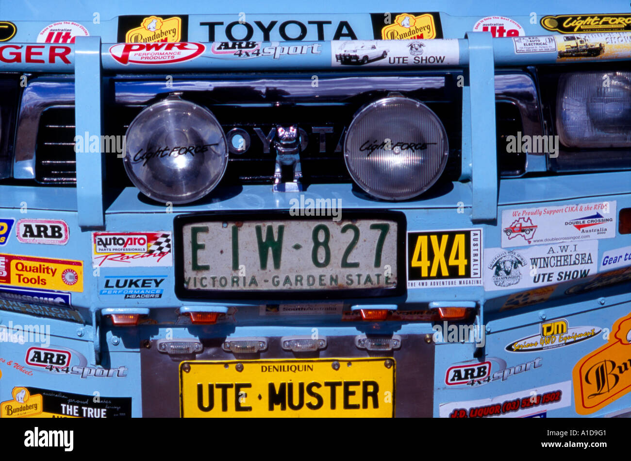 Front bumper of an Australian Ute (utility vehicle) showing registration plates, spot lamps and driver car related stickers and Stock Photo