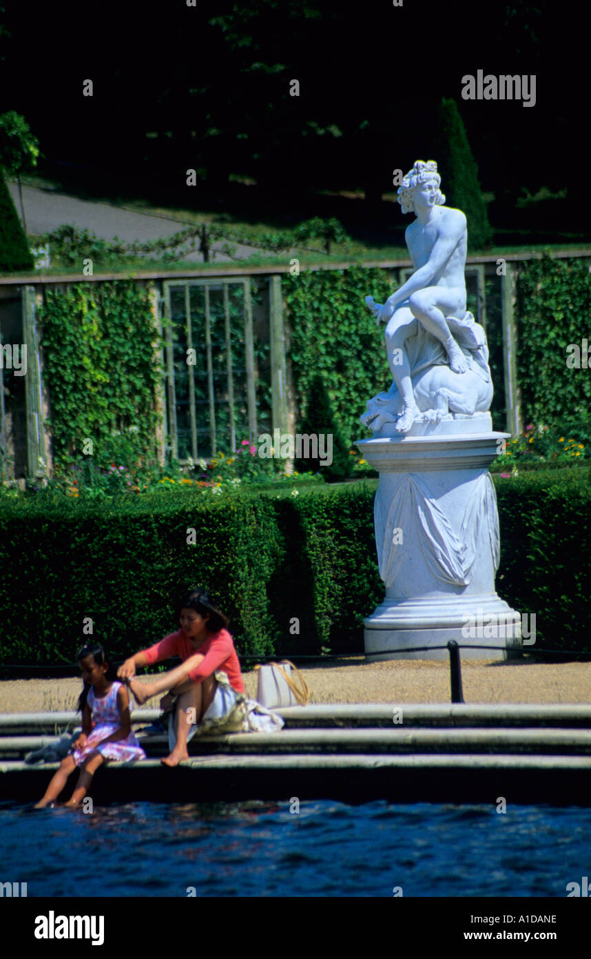 Woman and Daughter paddle in the fountain infront of the Schloss Sanssouci Potsdam Berlin Germany Central Europe Stock Photo