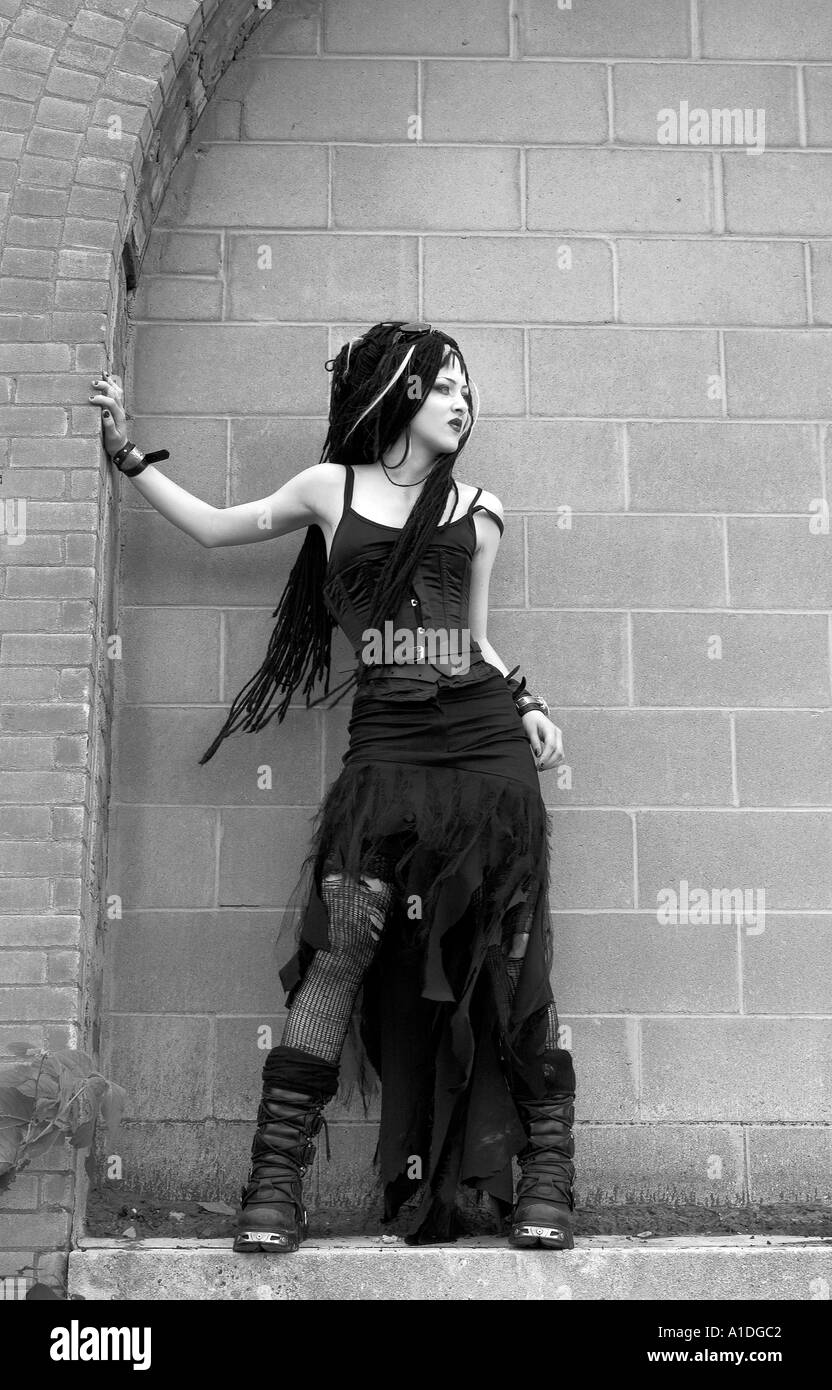 Goth girl standing on ledge Stock Photo