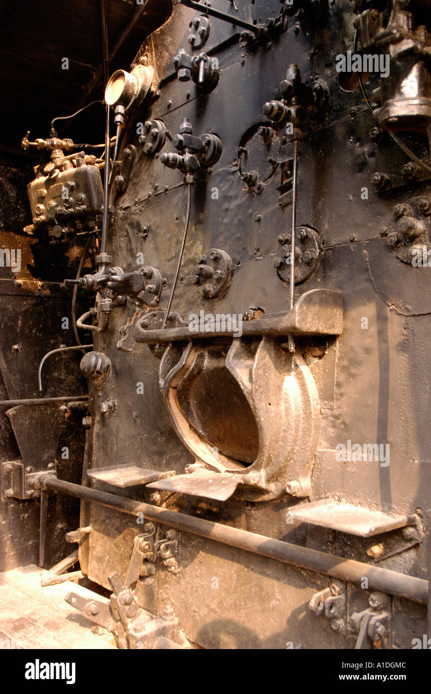 Steam Locomotive PT 11, British-built engine used in India. Detailed view of the vintage industrial firebox, controls, and mechanical components. Stock Photo