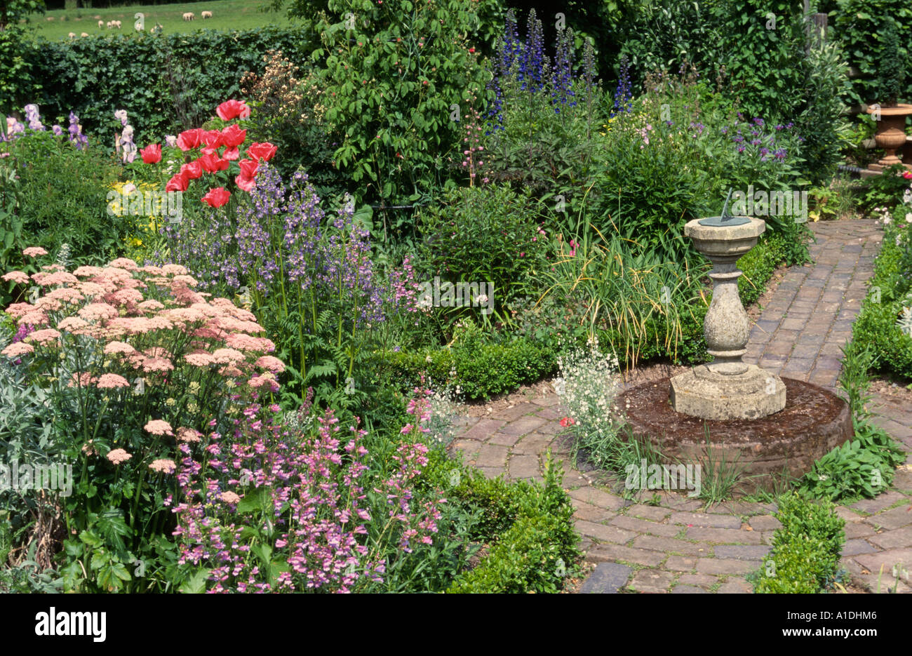 garden statue garden sundial on plinth Stock Photo