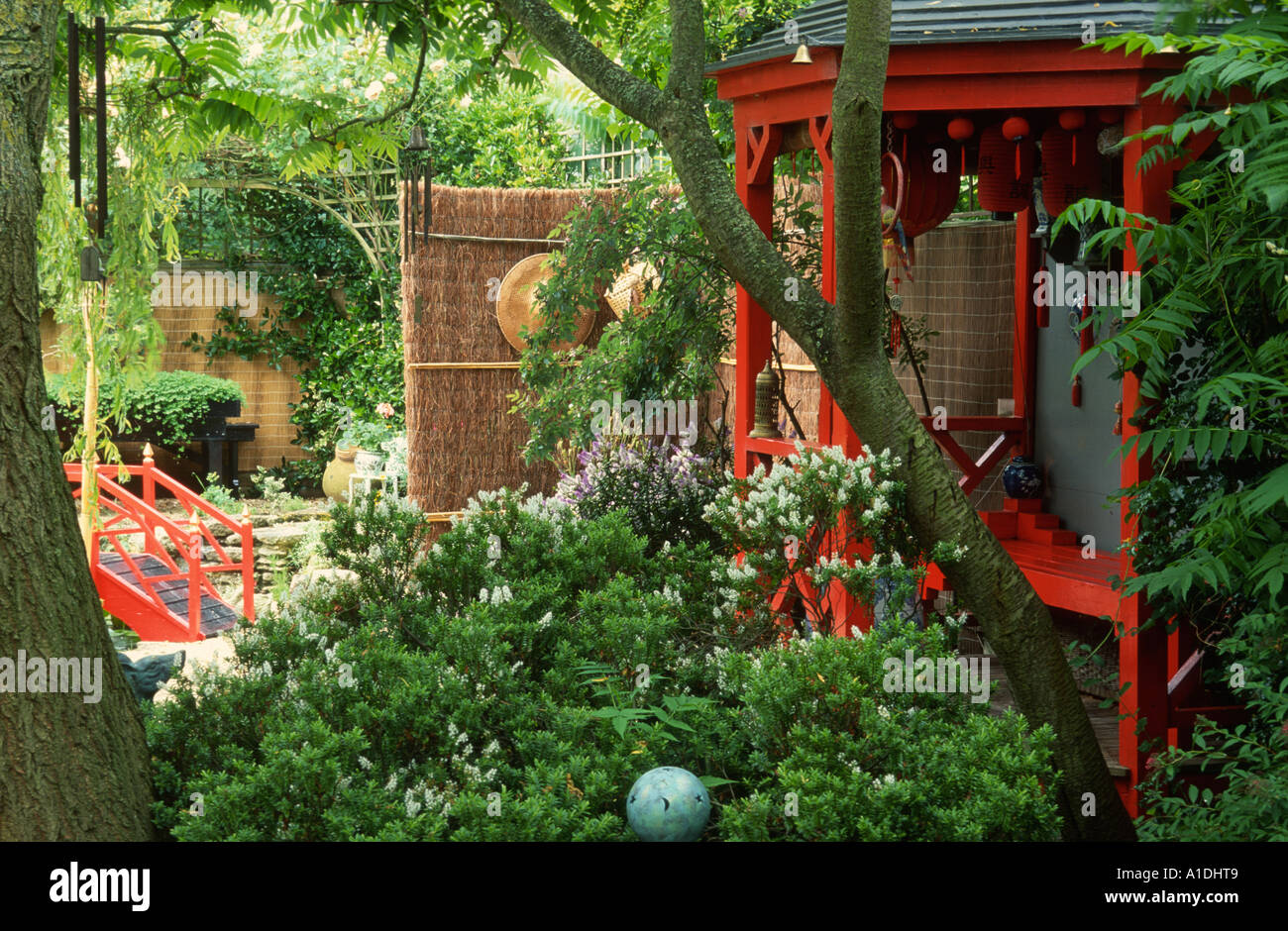 Japanese style garden with red painted tea house Stock Photo