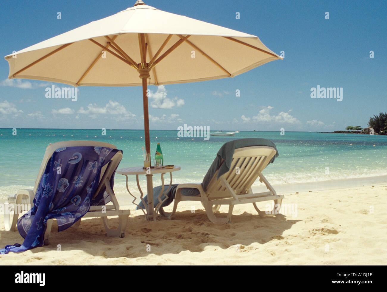 Parasol and sun loungers on the beach of the Royal Palm Hotel Mauritius Stock Photo