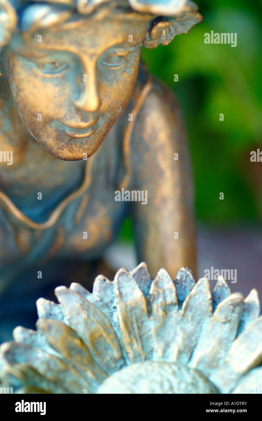Brass fairy statue sitting and holding flower bowl Stock Photo Alamy