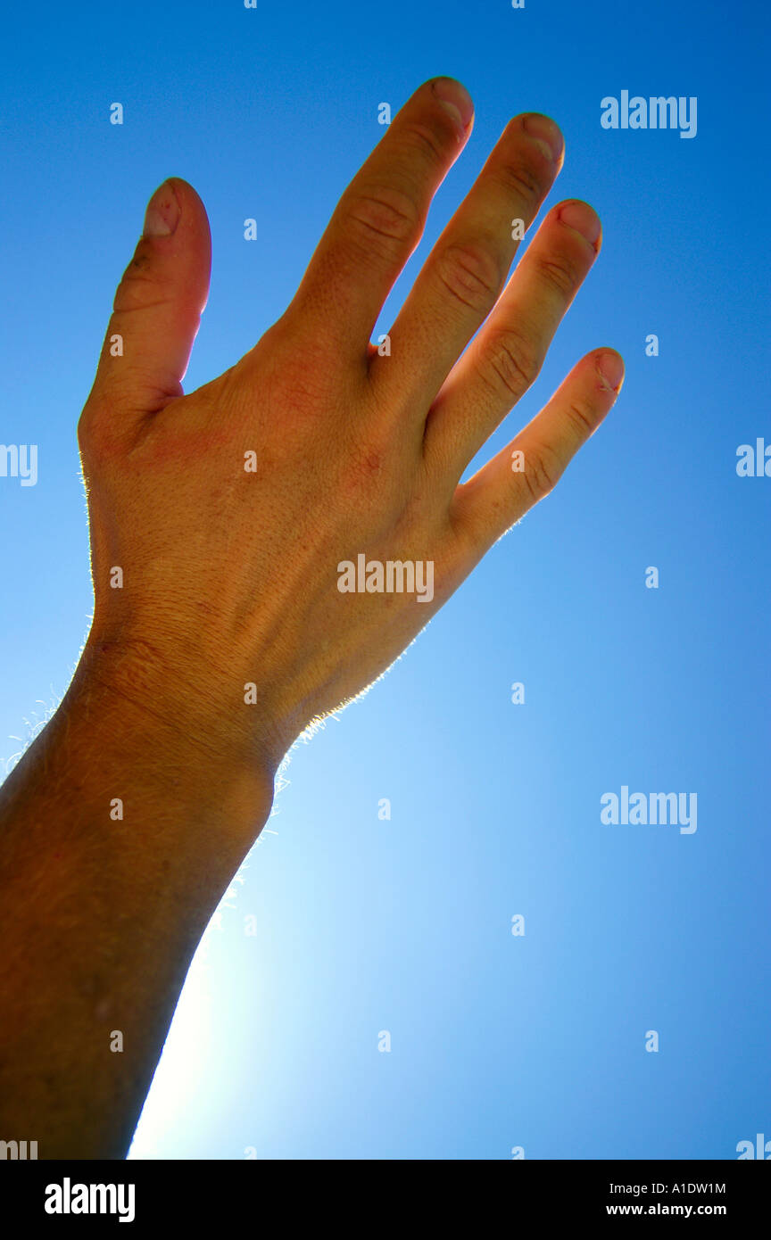 Open wrist hand palm over blue sky blocking sun Stock Photo - Alamy