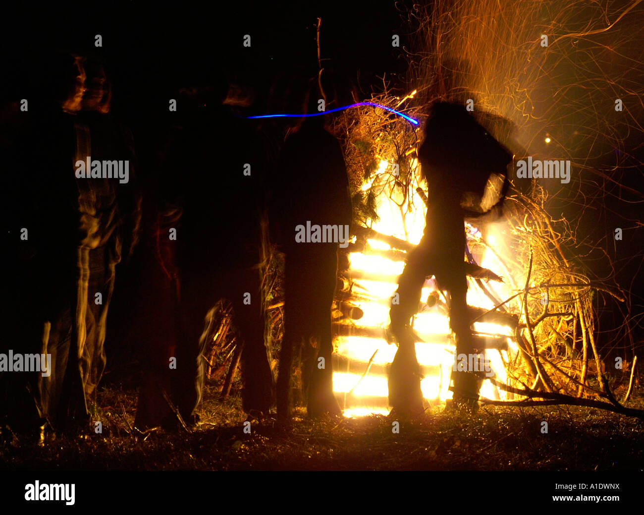 Figure body in front of huge flame fire blaze in night, Spirit of ...