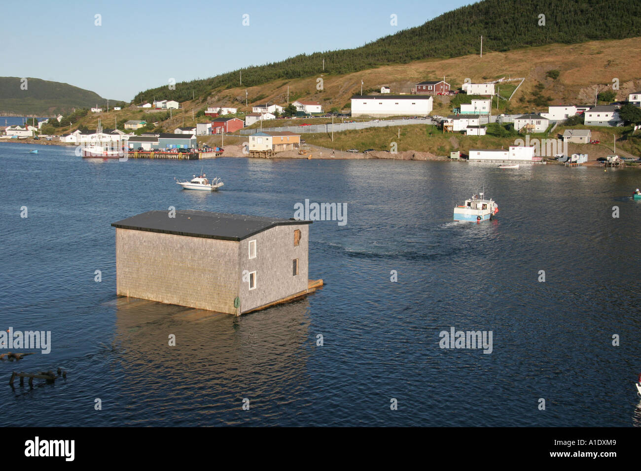 Piercey's Store is floated across the SW Arm of Harbour Breton