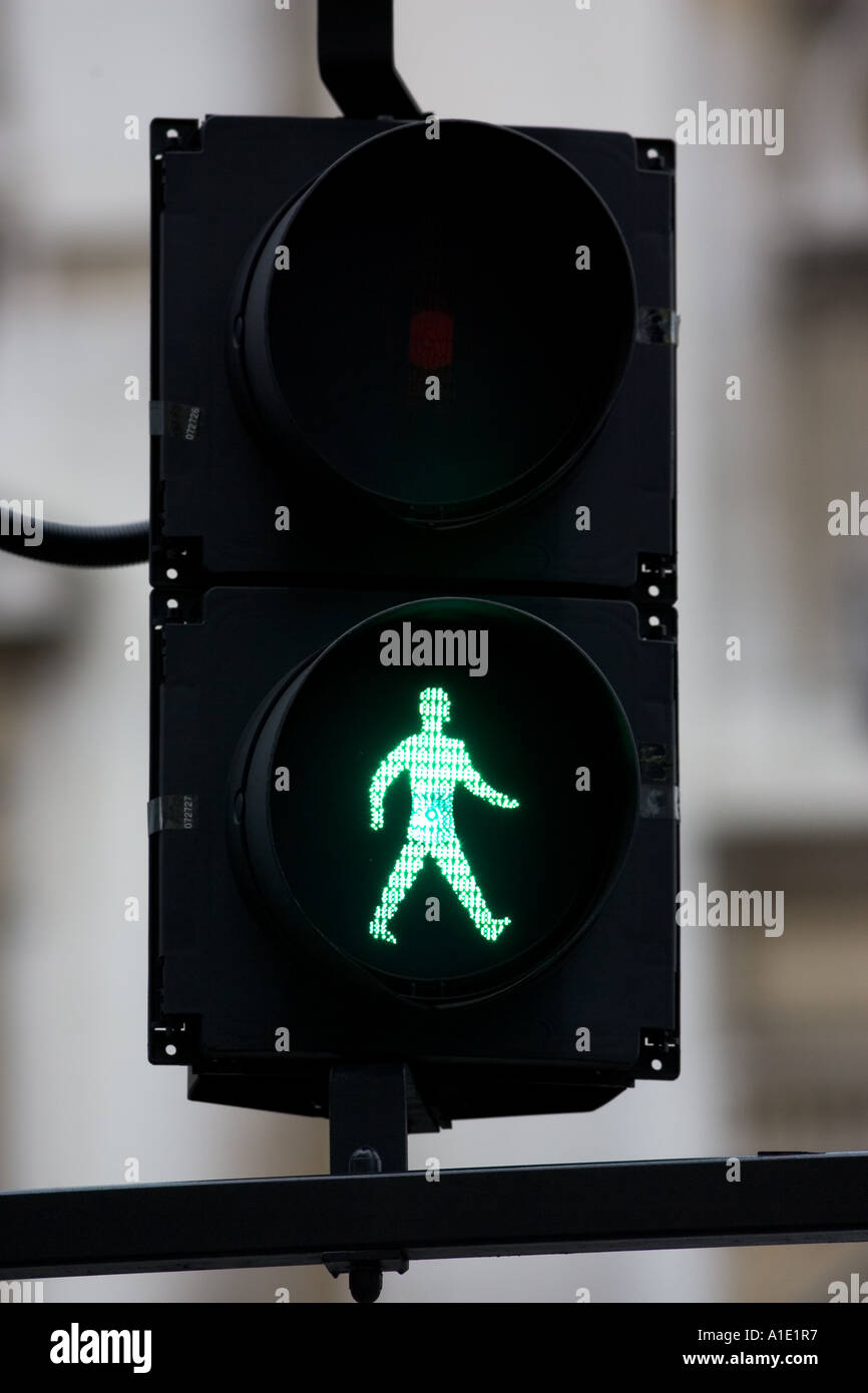 Green walk symbol on pedestrian crossing lights London United Kingdom Stock Photo