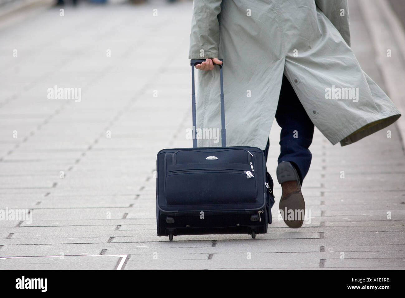 Commuter walking fast and pulling a suitcase London England United Kingdom  Stock Photo - Alamy