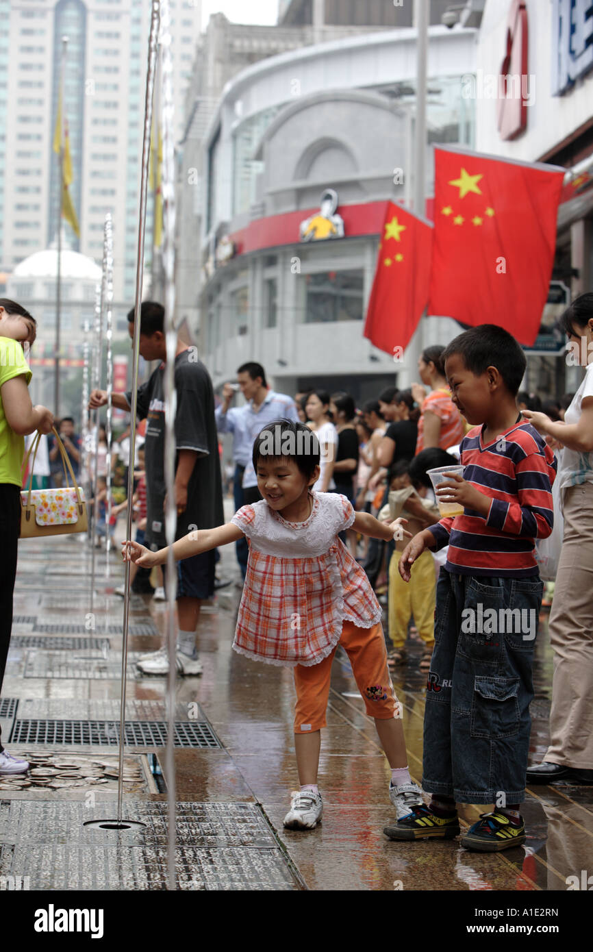 A chils plays in a fountain on Zhongshan Lu Guangzhou China Stock Photo