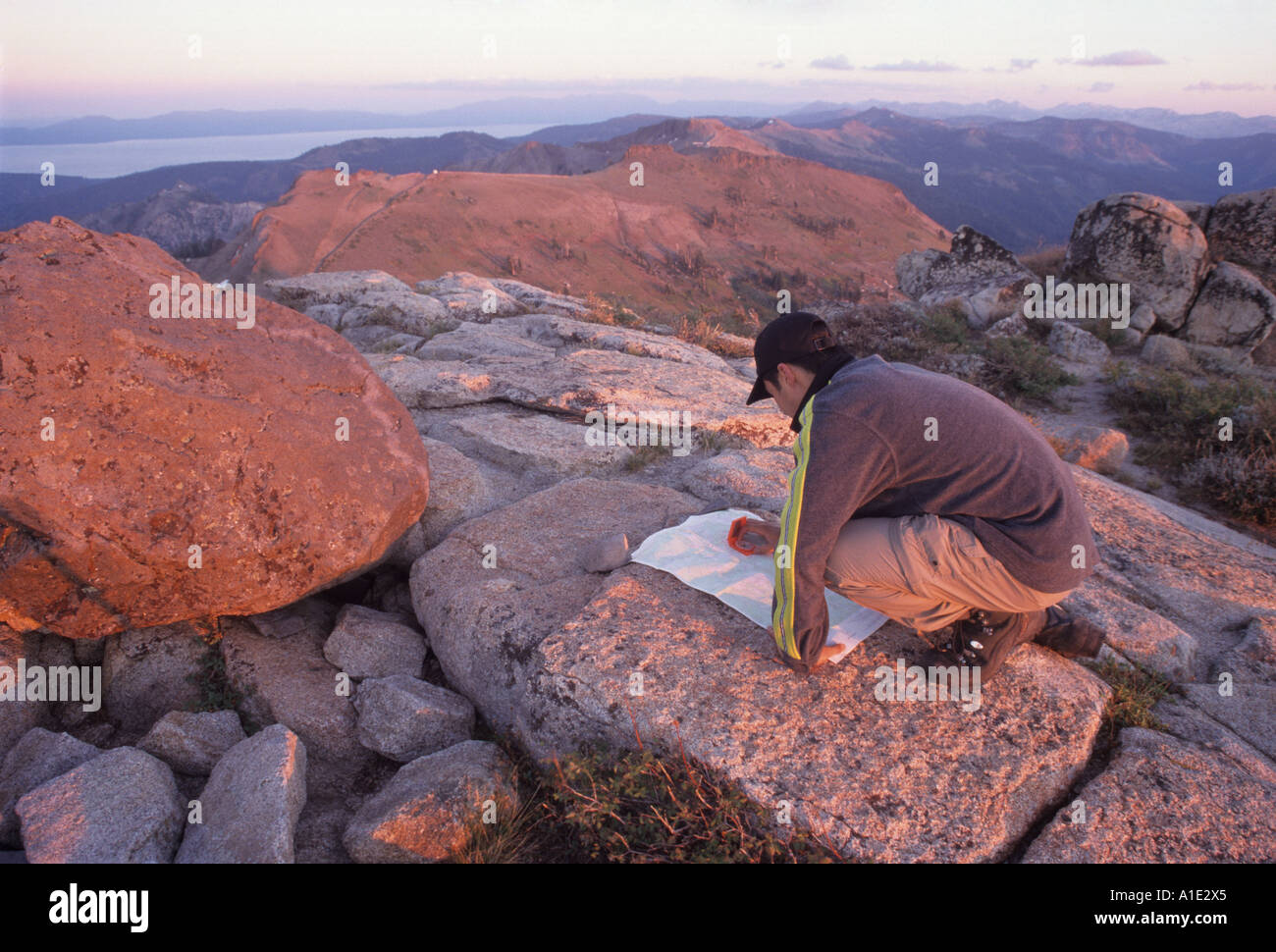 Navigating with map and compass on a mountain peak, Granite Chief