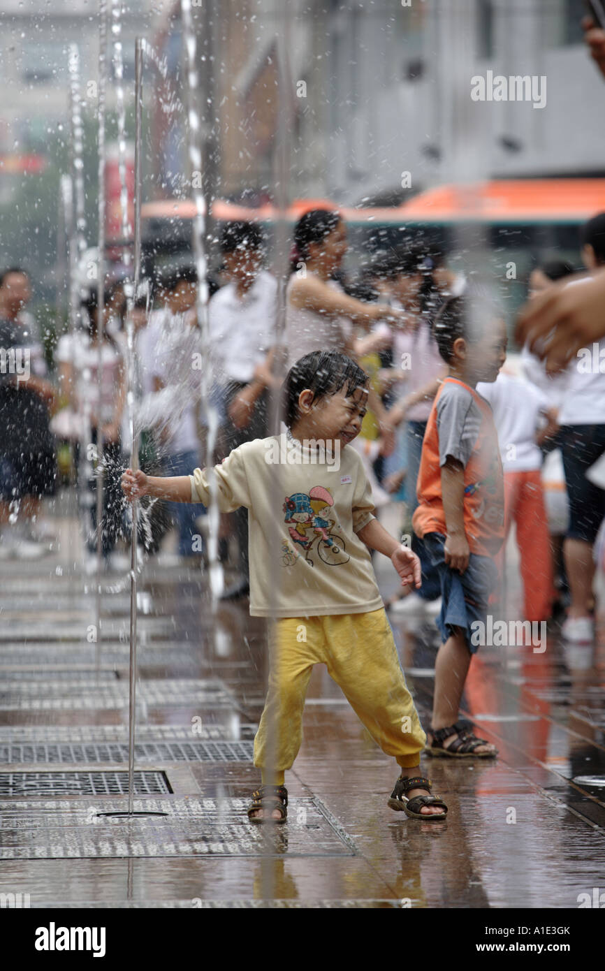 Child playing in a fountain Zhongshan Lu Guangzhou China Stock Photo ...