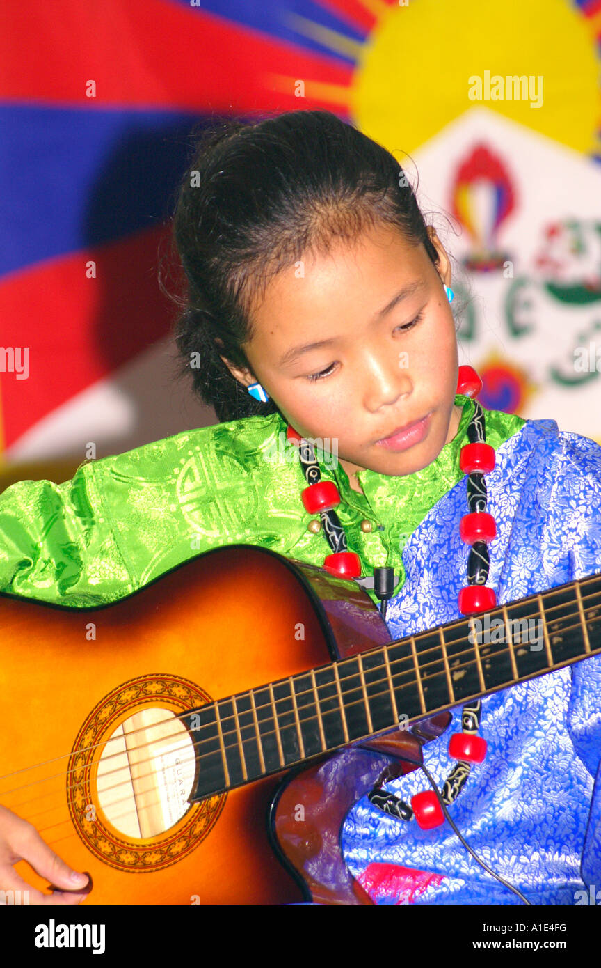 Young girl singer performer of tibetan arts music in front of national flag of tibet Stock Photo