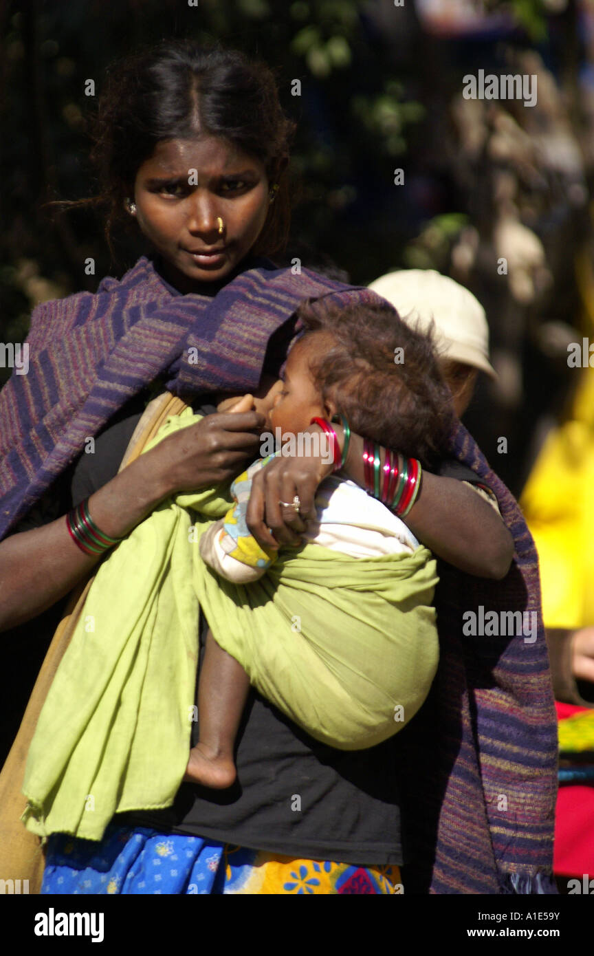 Young native indian beggar woman girl mother holding breastfeeding her