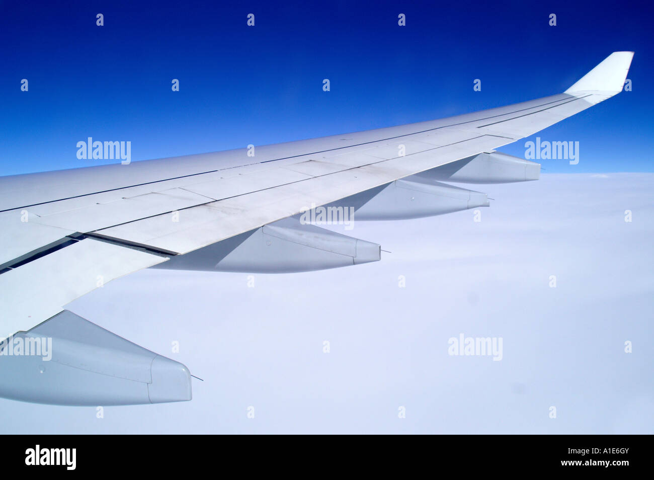 Airbus plane airplane wing above thick white bright cloud and azure