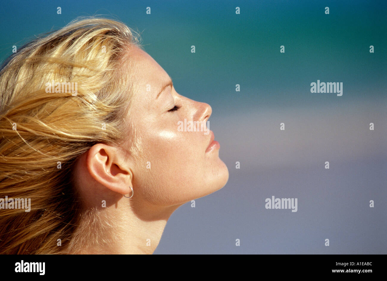 Profile of young woman at beach Stock Photo - Alamy