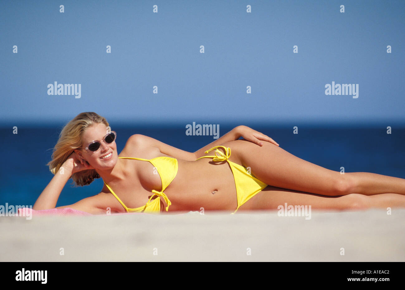 Teenager, girl in blue swimming suit on the beach Stock Photo