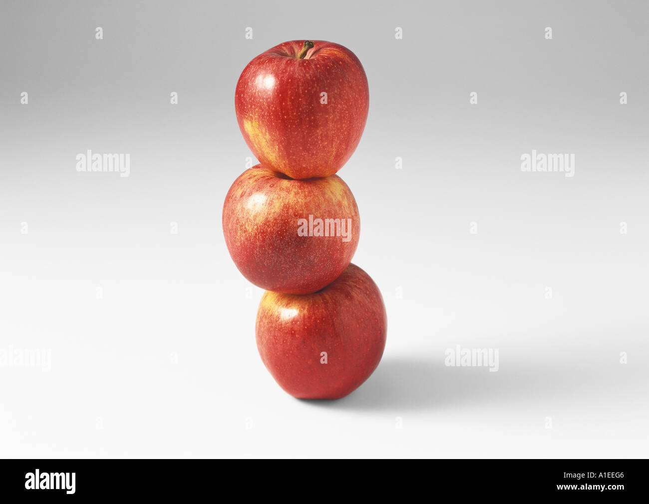 Three red apples, stacked one on the other Stock Photo