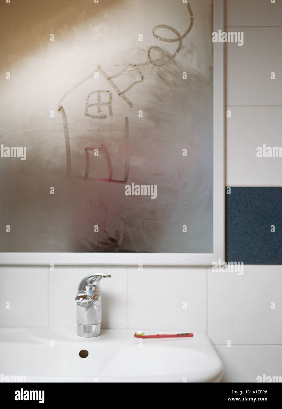 House drawn in condensation on bathroom mirror Stock Photo