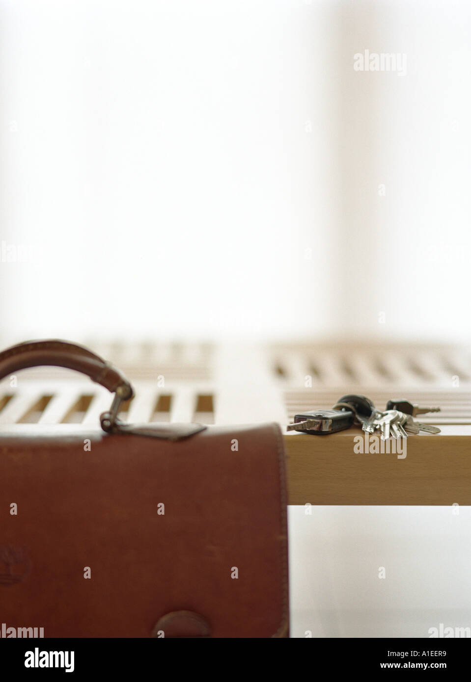 Briefcase and keys on table Stock Photo Alamy