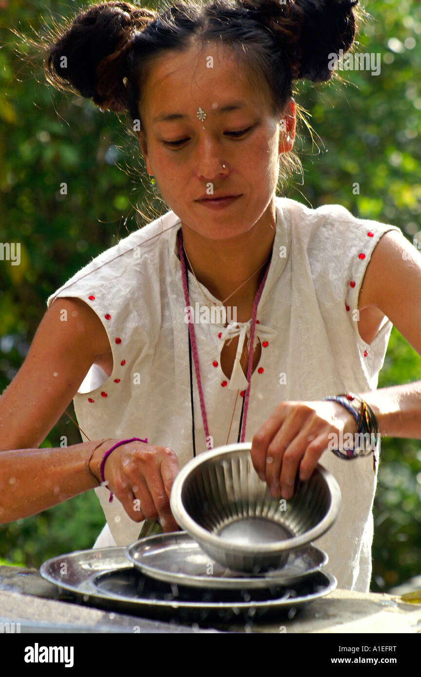 Asian chinese tibetan female washing dishes outdoors, facial portrait Stock Photo