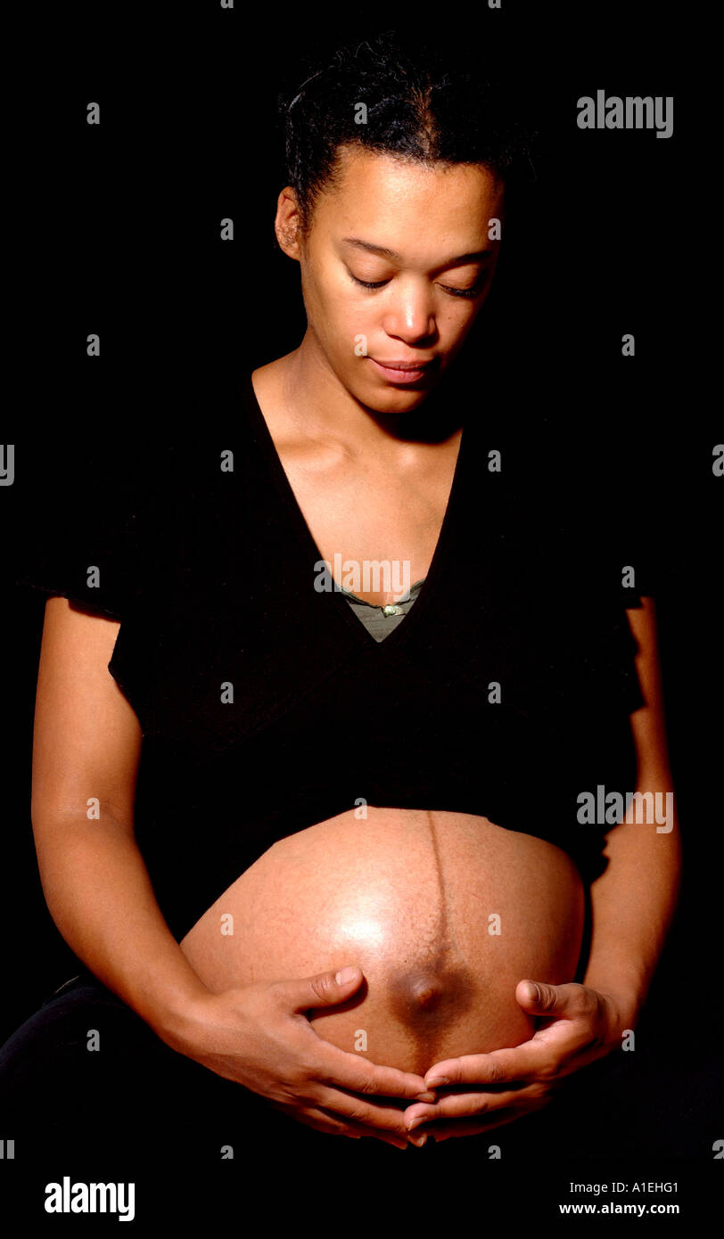 woman holding pregnant belly Stock Photo