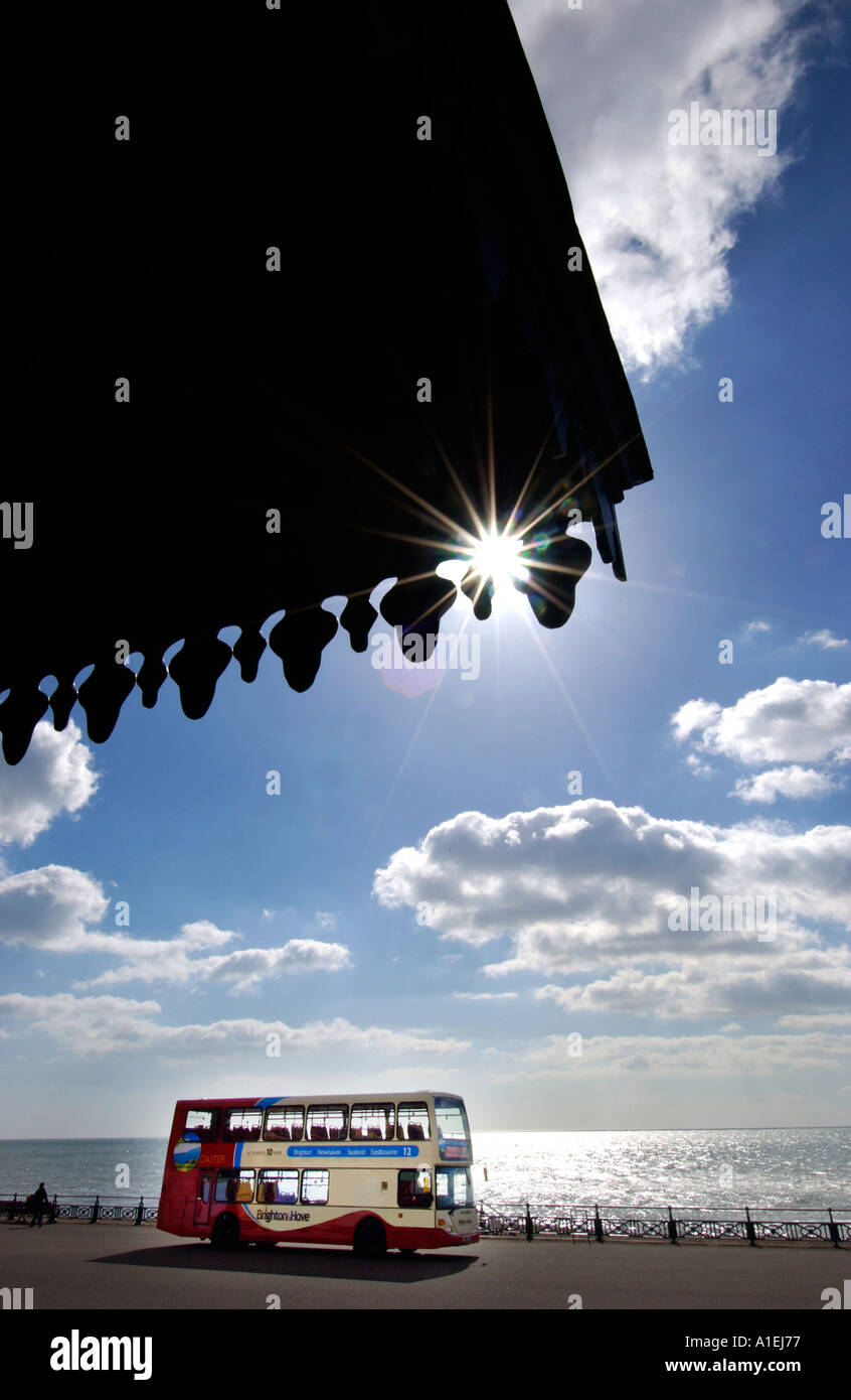 Double decker bus by the seaside at Brighton by a Victorian seafront shelter Stock Photo