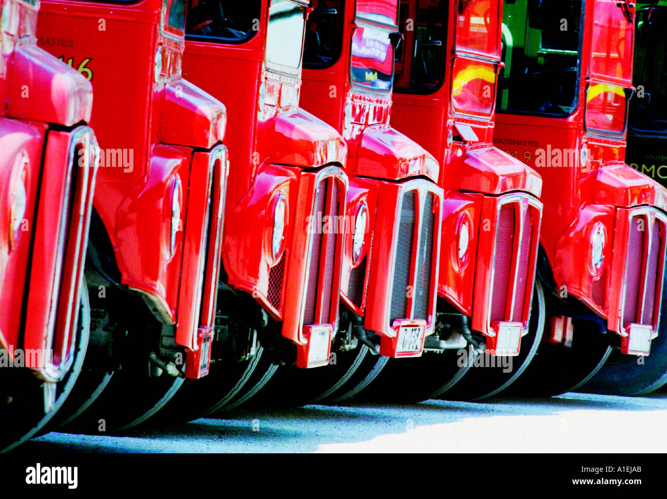 Six big red buses on parade. Stock Photo